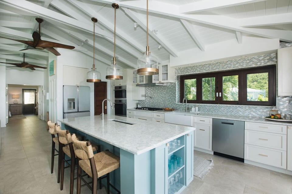 A dream kitchen with a pass-through bar to the porch and pool area.