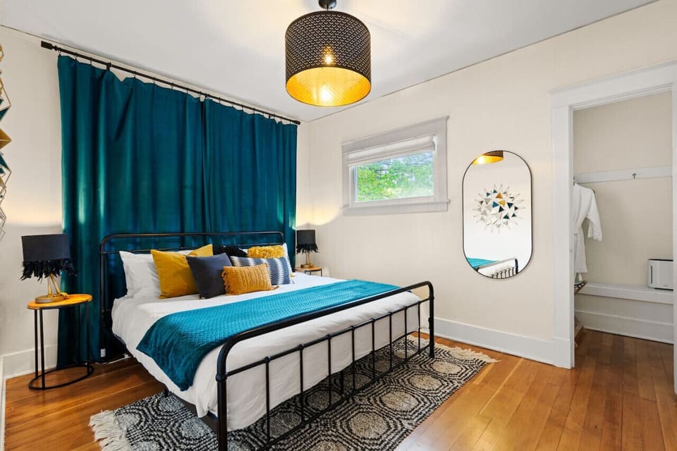 Bedroom #2 offers a striking king-sized bed set against bold blue tones for a stylish slumber.