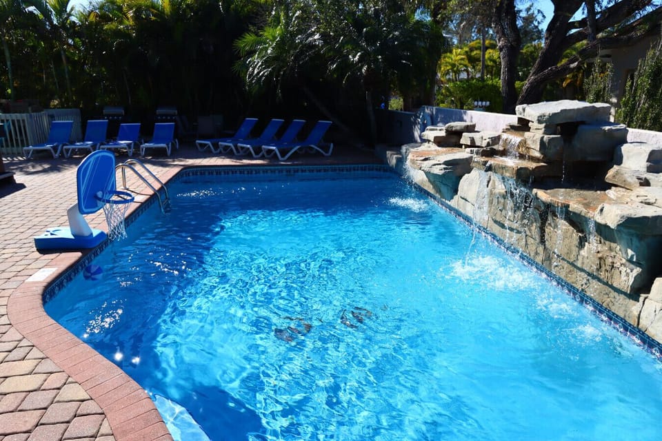 Pool view with lounge area and waterfall.
