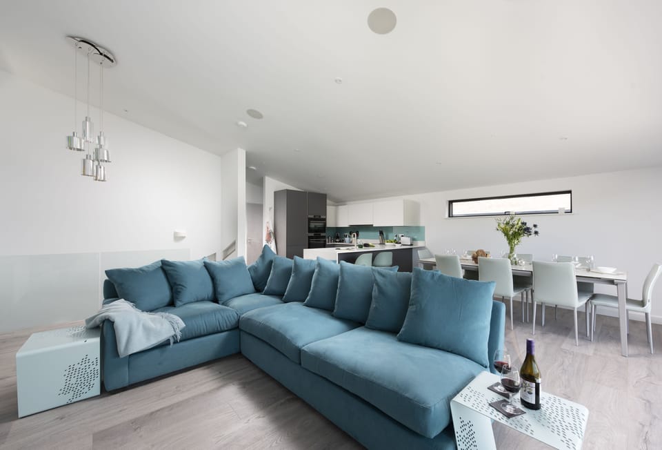 The Shore, Mawgan Porth. First floor: Comfortable corner sofa flanking the gas fire