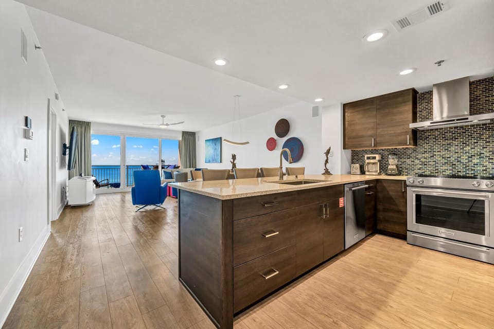 Your modern kitchen flows seamlessly into the living area, where stunning gulf views create the perfect backdrop for cooking and relaxing together.
