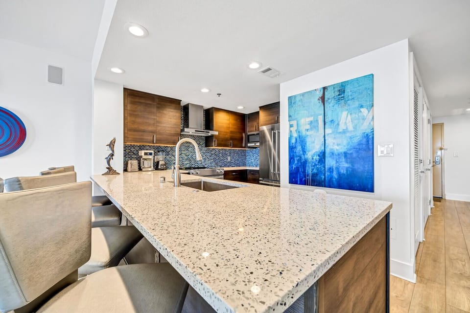 You'll love cooking in this sleek modern kitchen with granite counters, stainless appliances, and stylish bar seating for casual meals.