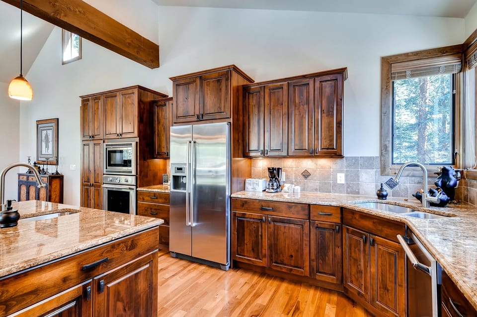 The kitchen comes equipped with Bosch and Thermadore appliances, a large island, and plenty of space.