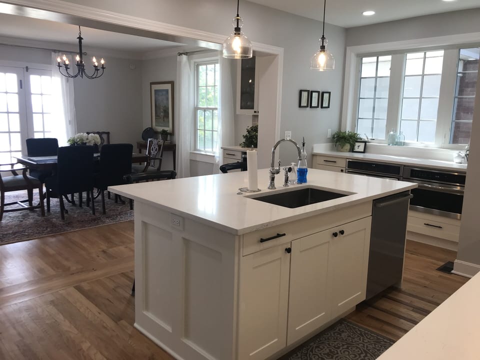 View from pantry area showing dining\work area with bar and background