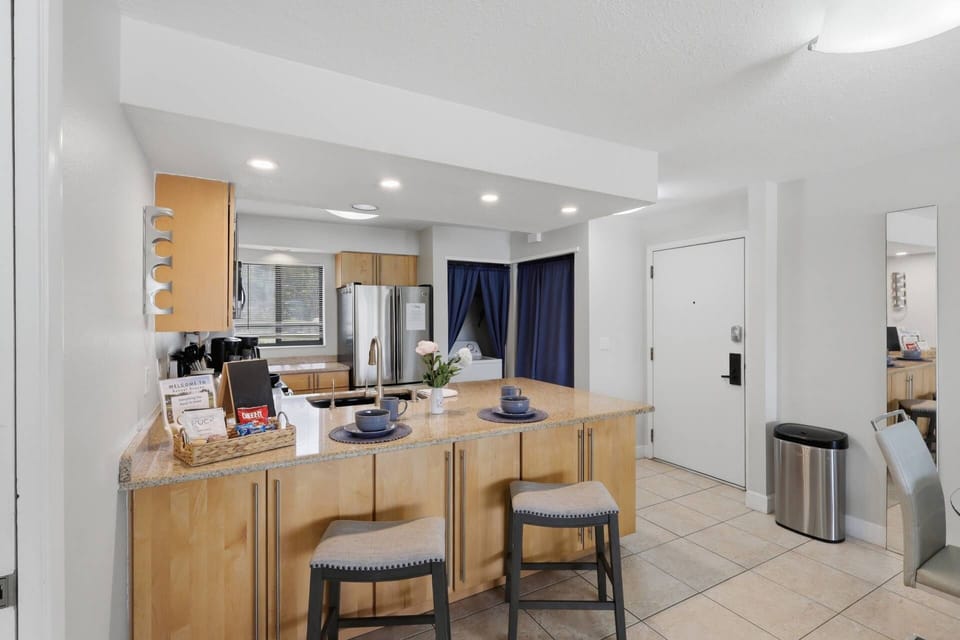 Stylish kitchen and entryway with contemporary finishes — clean, bright, and thoughtfully designed for a seamless stay.