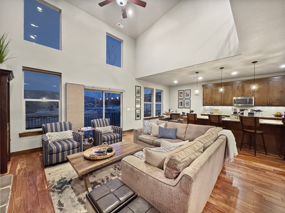 The living area is adjacent to the dining table and kitchen in this open concept floor plan...
