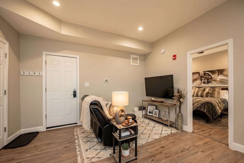 Living area with TV seating and direct view into the bedroom.