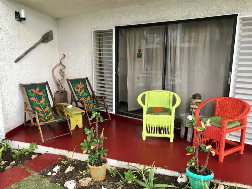 Relax on the private terrace, steps from the pool and ocean.  