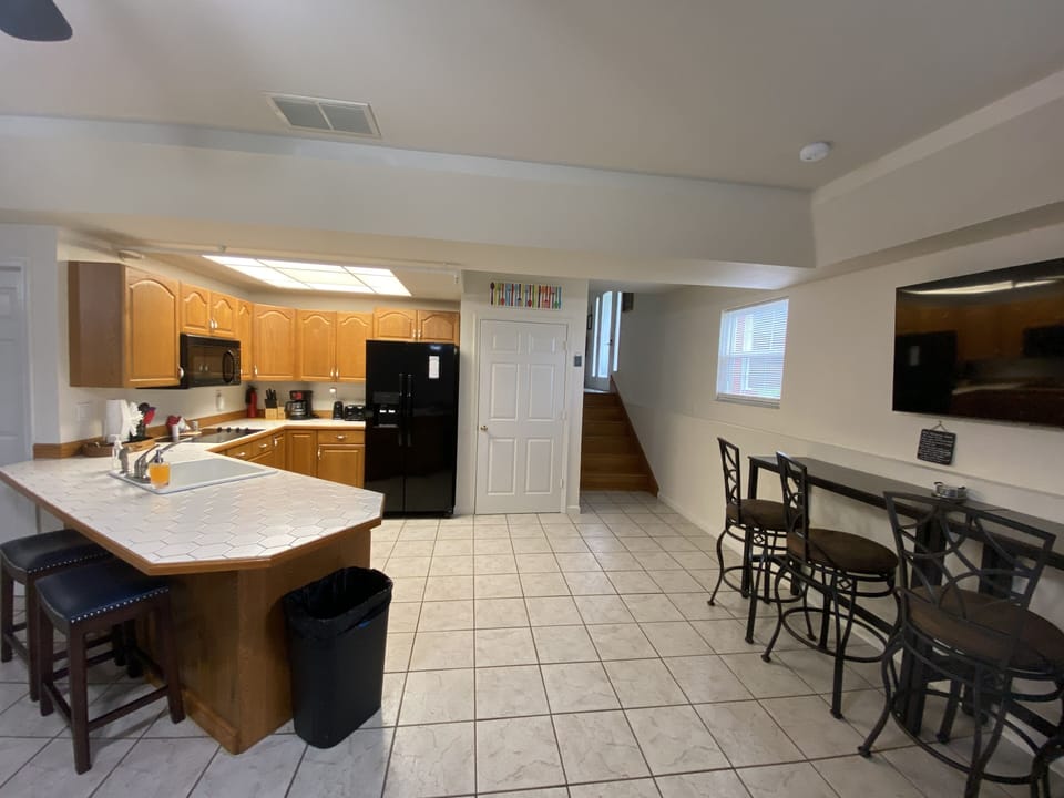 Downstairs Kitchen with Stove top, microwave and fridge with ice maker in door.