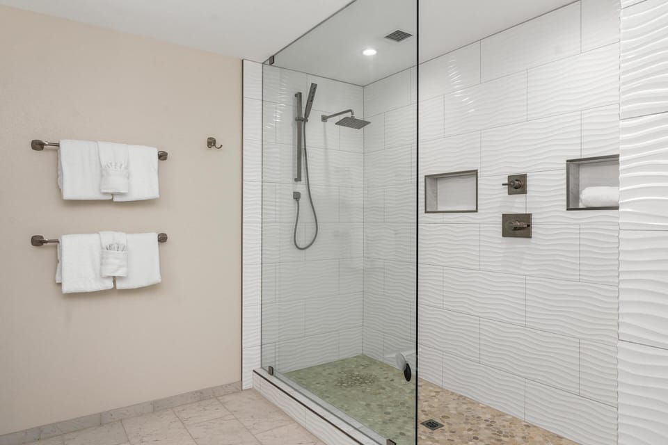 Ensuite primary bathroom with walk in shower with rainfall head