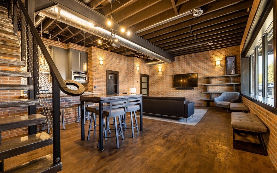 Main level open floor plan with multiple gathering spaces and custom kitchen offers flexibility for your group