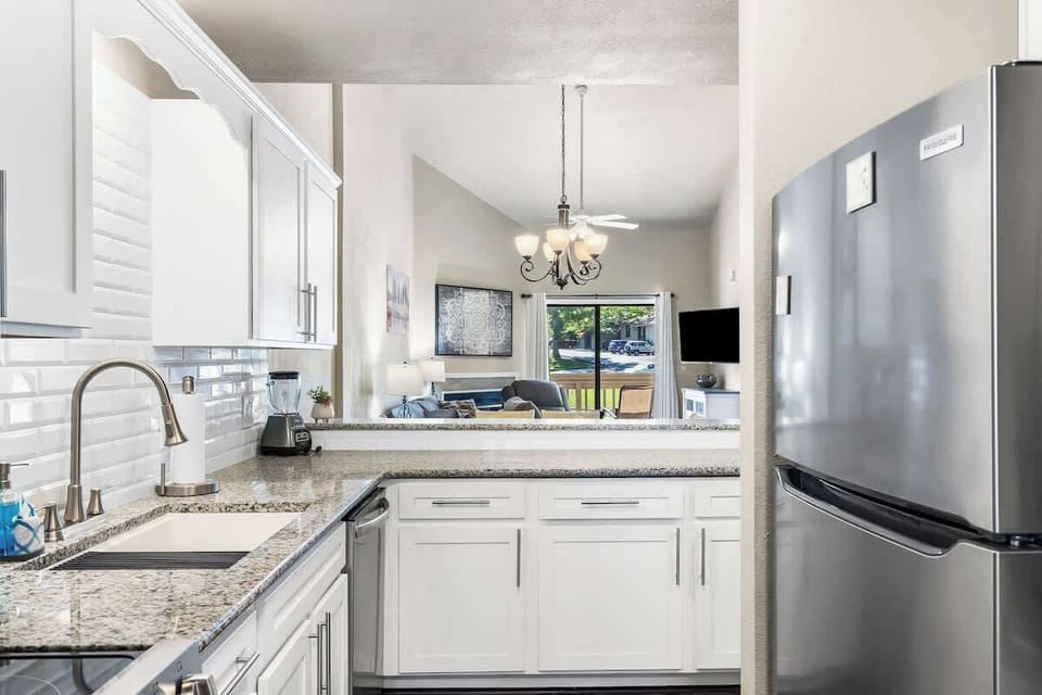 Kitchen with new stainless steel appliances and granite countertops. 