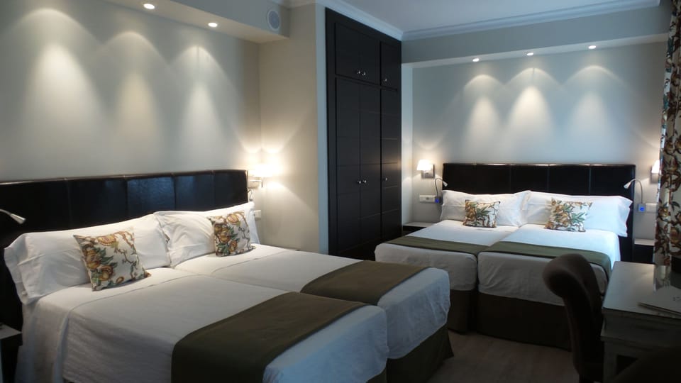 Quadruple Room | Down comforters, in-room safe, desk, blackout drapes