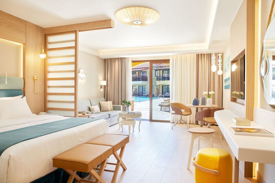 Junior Suite Pool or Sea View | Premium bedding, minibar, in-room safe, desk
