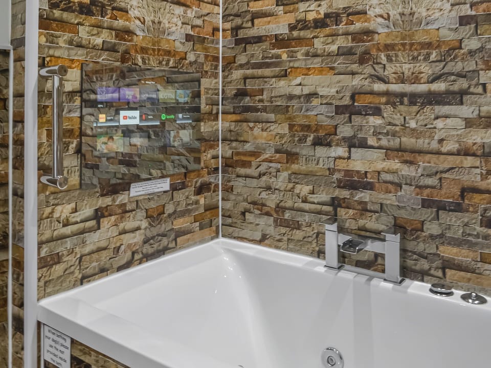 TV over the jacuzzi bath | The Old Stables, Rothbury