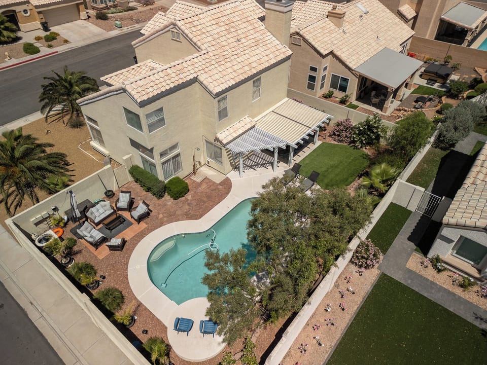 property entrance, outdoor pool, summer, aerial view, pool visible, daytime