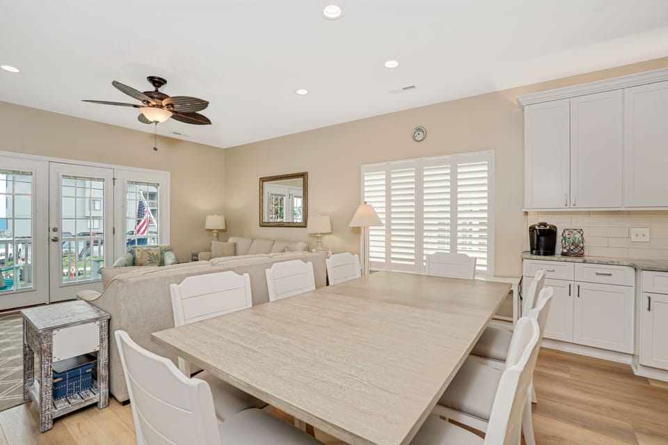 Gather around this spacious dining table where your group can share meals and memories in the bright, airy atmosphere.