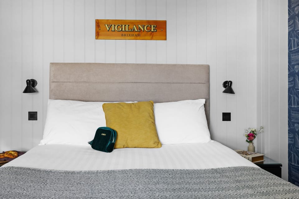 King sized bed with bedside tables and lights - Vigilance Suite