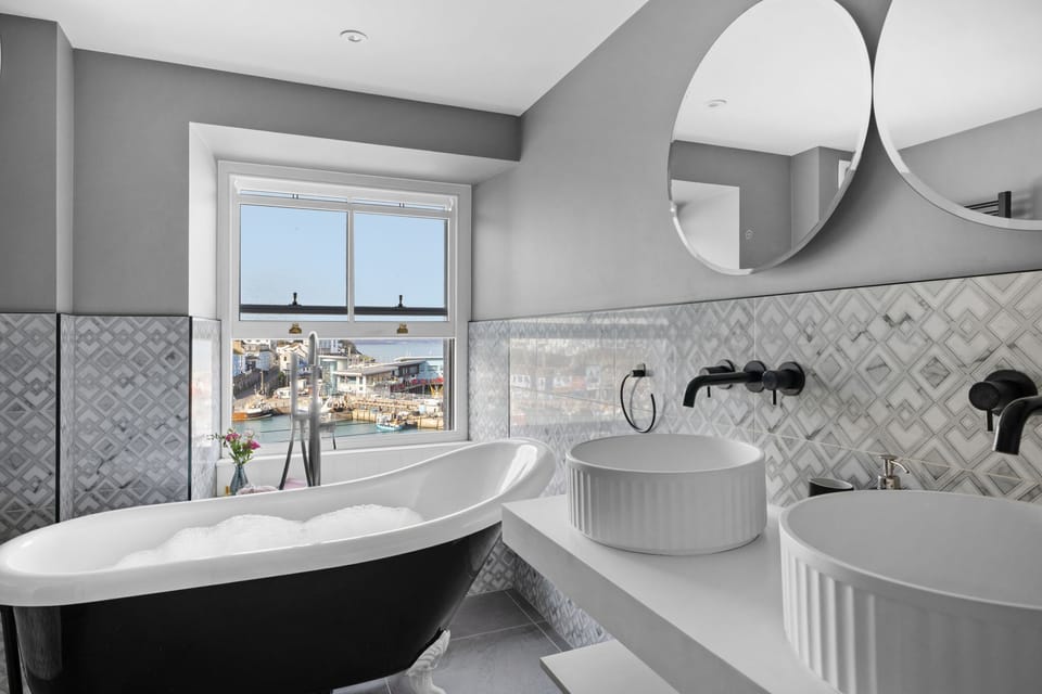 Modern bathroom with freestanding bath and twin basins - Vigilance Suite