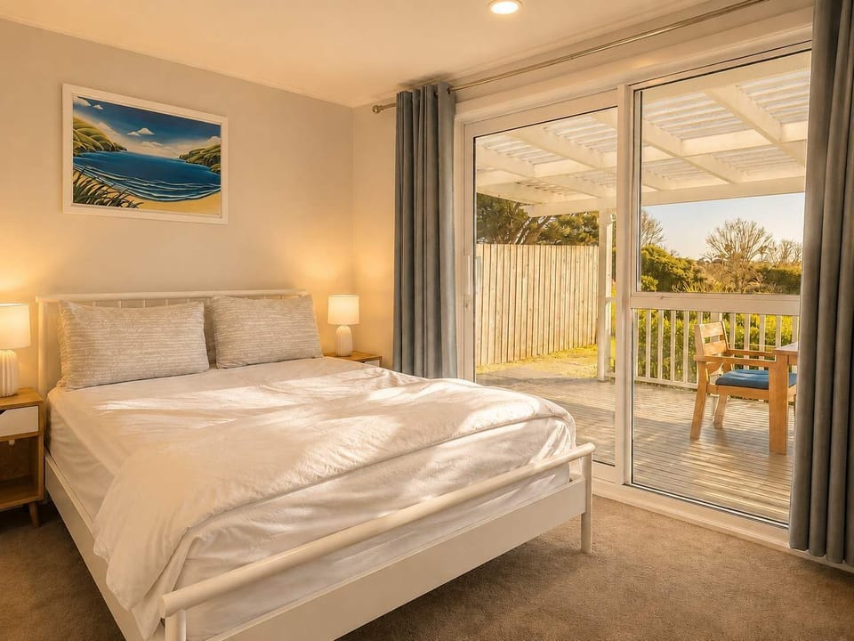 Bedroom 1 is the last room at the end of the hallway and the sliding door leads onto the front deck. 