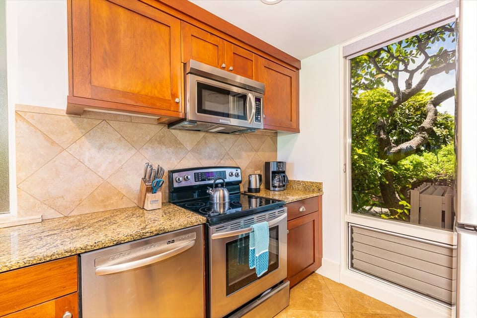 Beautiful kitchen with stainless steel appliances, granite countertops, and wooden cabinetry.