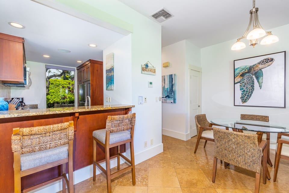 Breakfast bar with seating and open view to the kitchen.