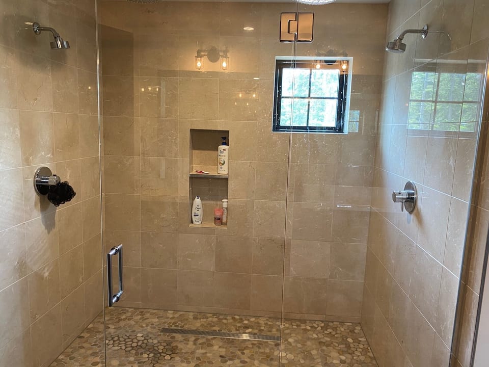 Fit for a King: - Dual shower head in the master bath walk-in tile shower.