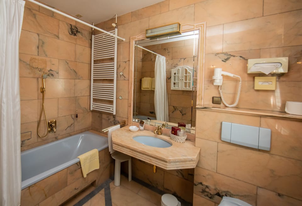 Bathtub, hair dryer, towels, soap