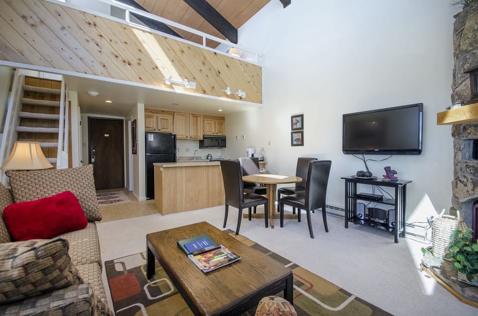 Your spacious loft-style retreat features soaring wood ceilings, a cozy fireplace, and modern amenities for the perfect mountain getaway.