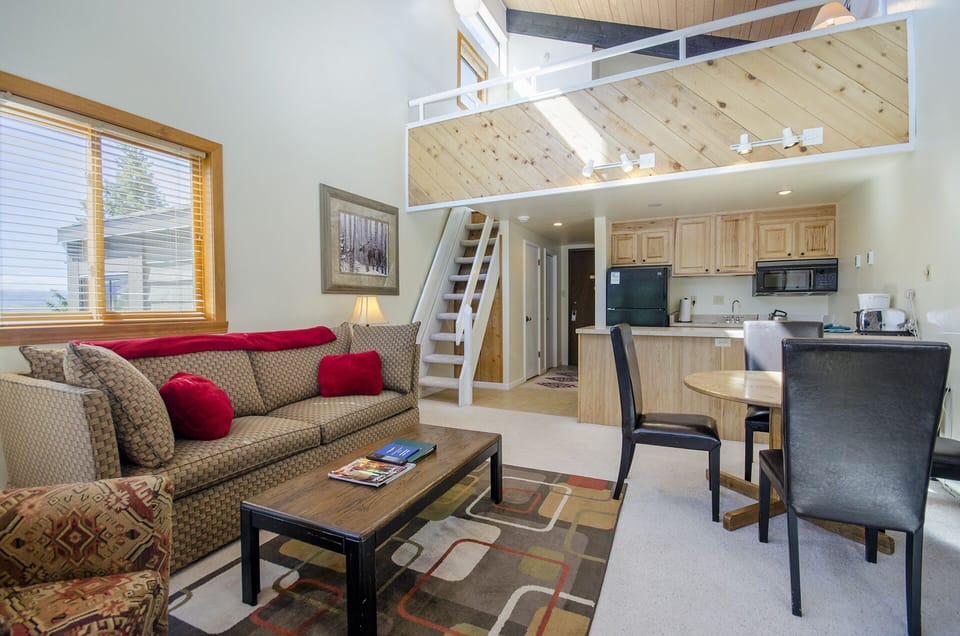 Relax in your spacious loft-style retreat with soaring ceilings, cozy seating, and a fully equipped kitchen for memorable mountain getaways.