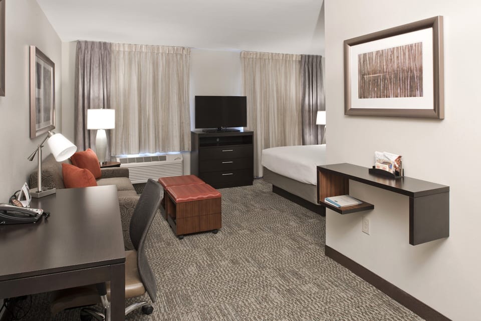 Premium bedding, desk, laptop workspace, blackout drapes