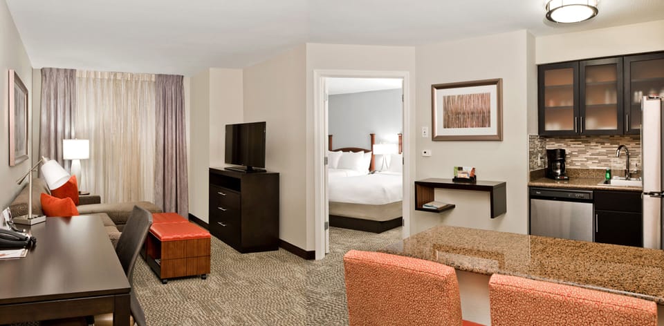 Premium bedding, desk, laptop workspace, blackout drapes
