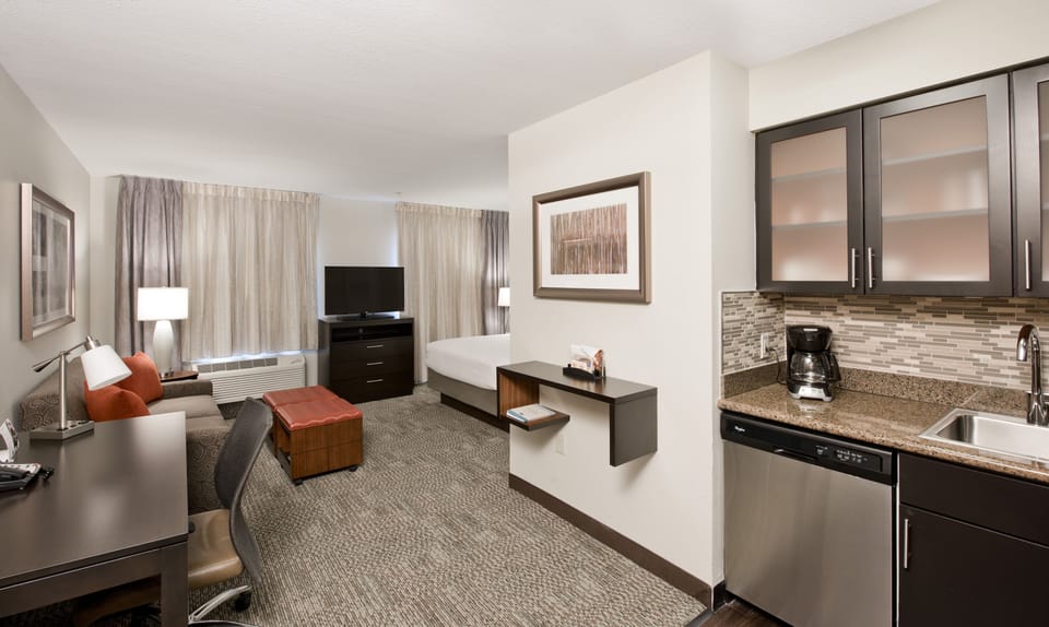 Premium bedding, desk, laptop workspace, blackout drapes
