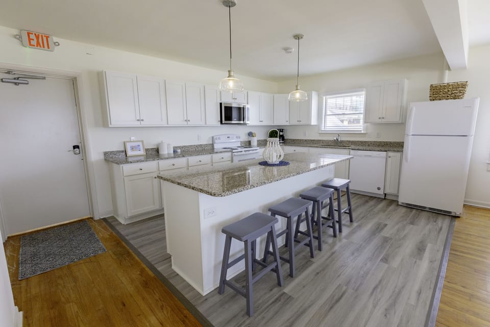 Kitchen with island and bar seating.