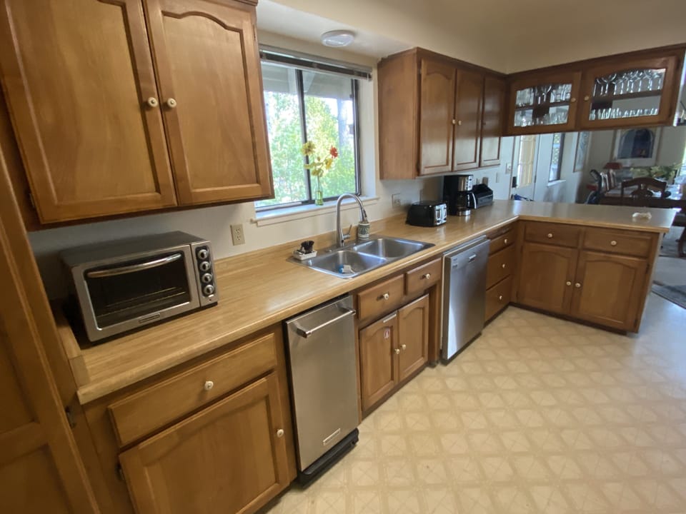 Bar seating with wine and cocktail glasses and a pass through countertop 