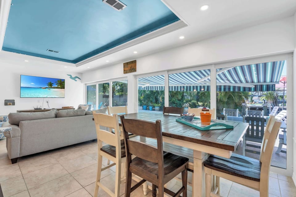 The dining set seats 6 and has direct pool and lanai access along with beautiful views of the outdoor space behind the home 