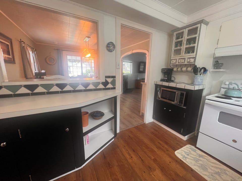 Step into your cozy kitchen where rustic wood beams meet modern convenience, creating the perfect space to prepare meals and gather.