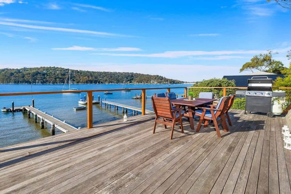 Large deck on top of the house with dining table and BBQ