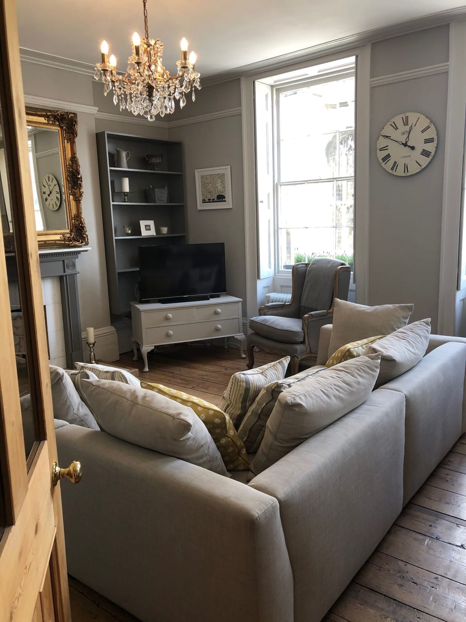 The chandelier and gilt edged mirror add a little bit of luxury to this room