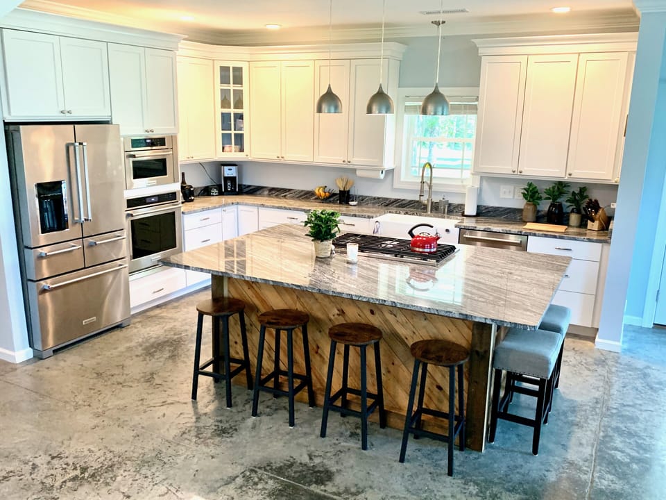 modern kitchen with eat in island that can seat 6
