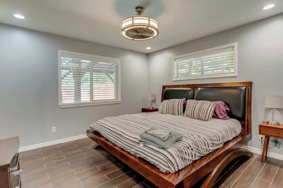 Primary bedroom with a king bed, a TV and soft lighting for a restful night.