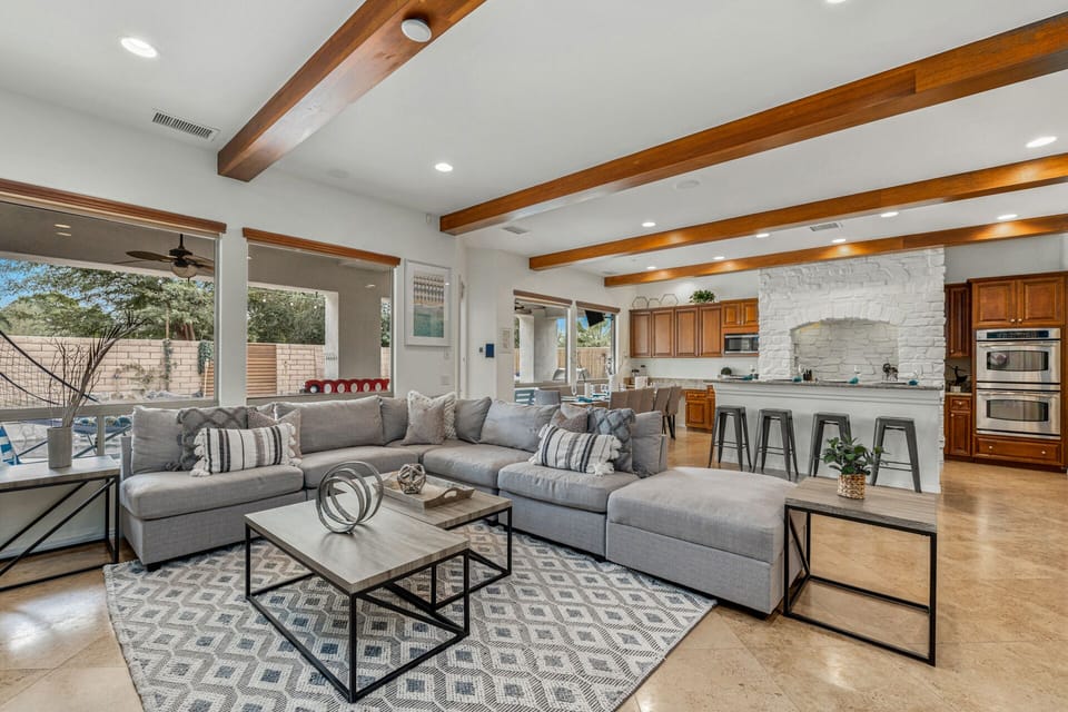 The living area opens directly to the outdoor patio and pool area