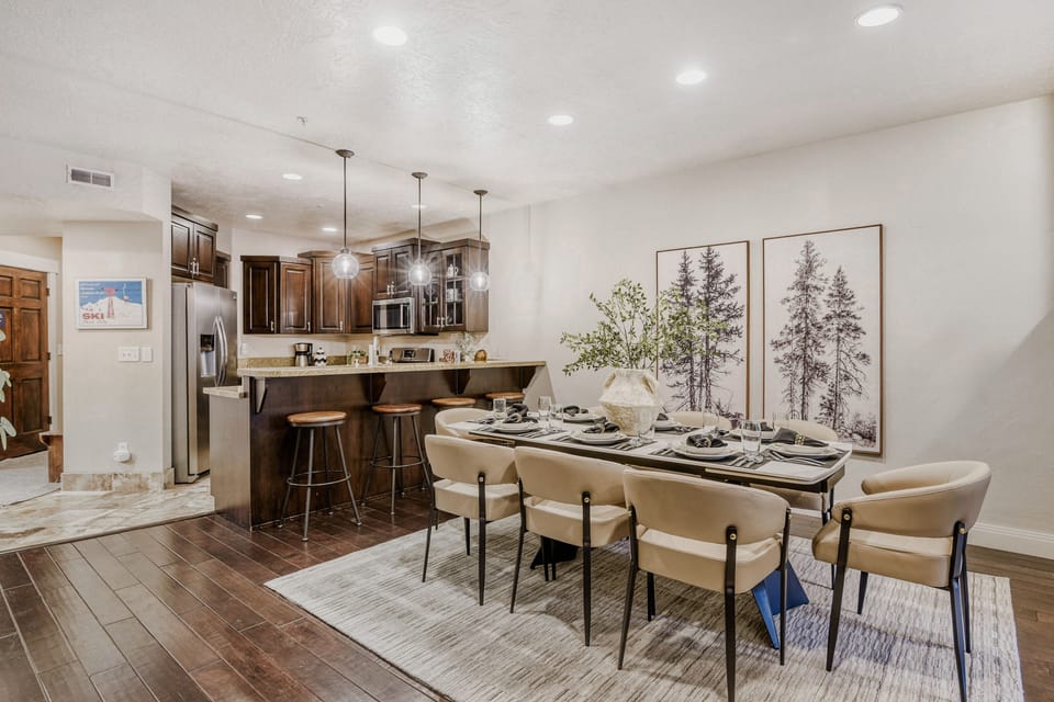 Gather your group around this elegant dining table, perfectly positioned next to your fully equipped kitchen with modern appliances and stylish breakfast bar.