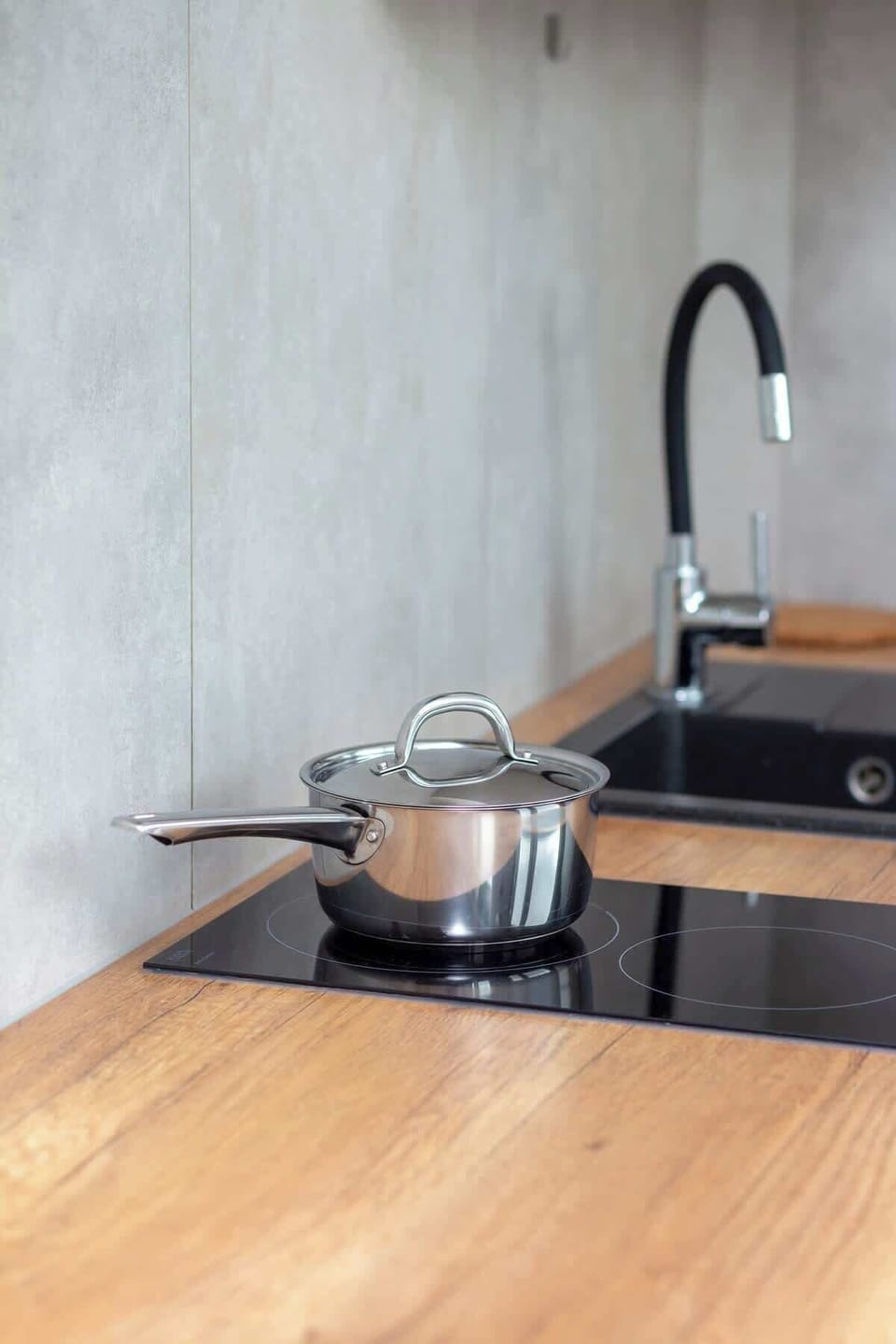 Functional kitchen area with induction stove and sink.