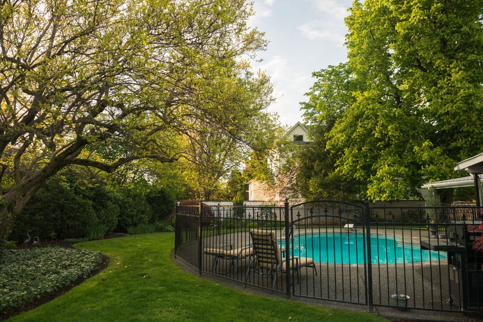 Manicured grounds surround the pool and house