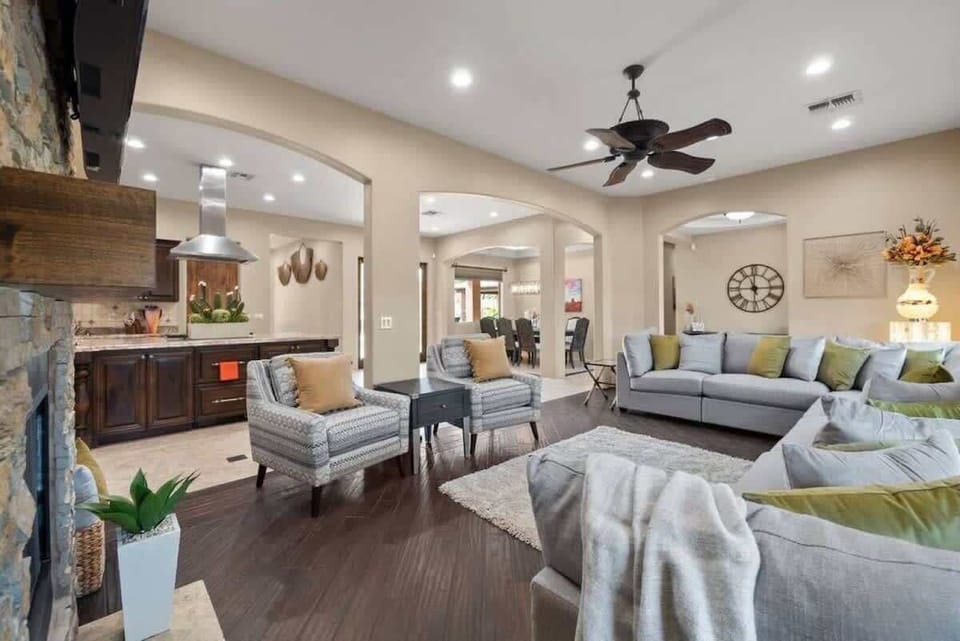 Settle into this open-concept living space where contemporary elegance meets comfort. Plush sofas invite you to relax under elegant arched doorways, while the adjoining kitchen awaits your culinary adventures.