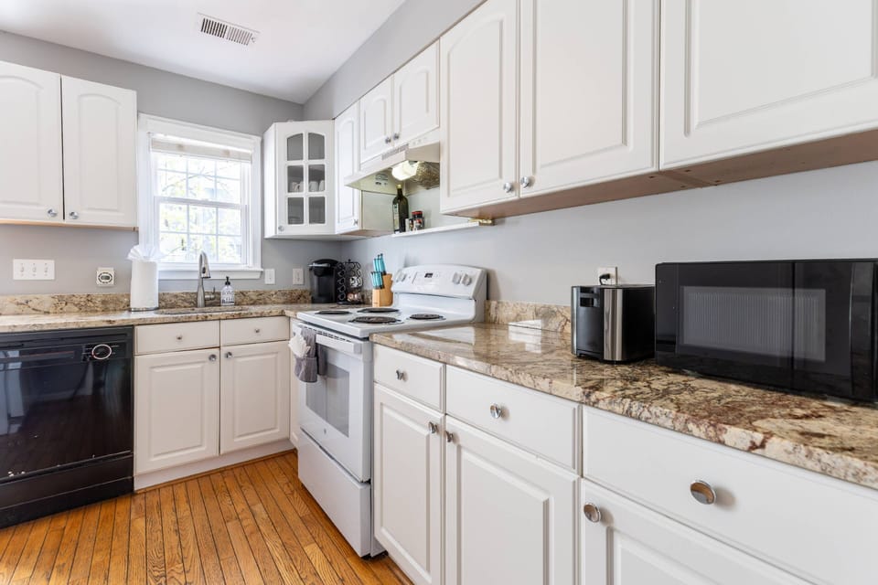 The kitchen is fully-stocked with cookware, dining plates and silverware.