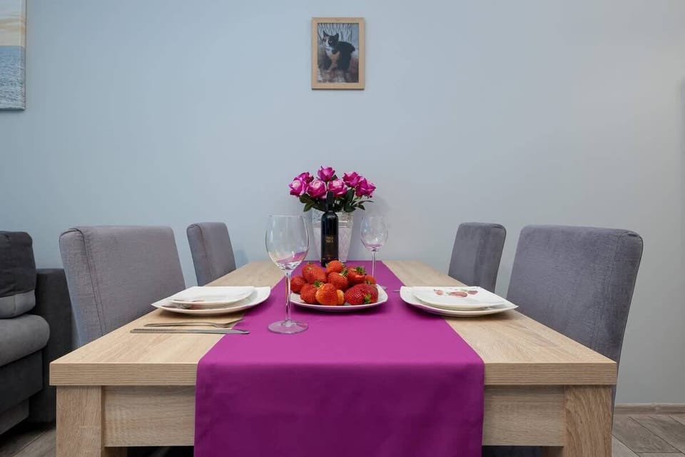 Another view of the dining area in the studio with a pink table centerpiece.