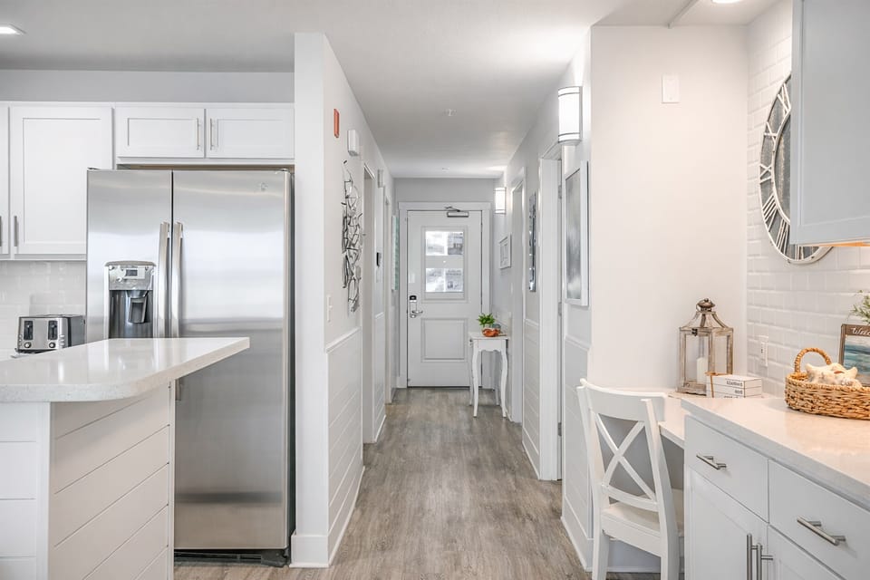 Light wood floors and easy flow pull you straight into the kitchen and living areas. It feels welcoming in that “we’re going to make good memories here” kind of way, tying right into the bright dining room waiting ahead.