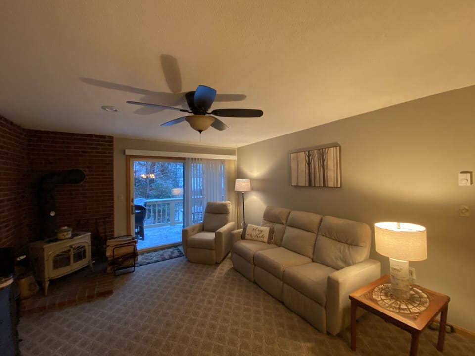 Living room and fireplace over looking the deck
